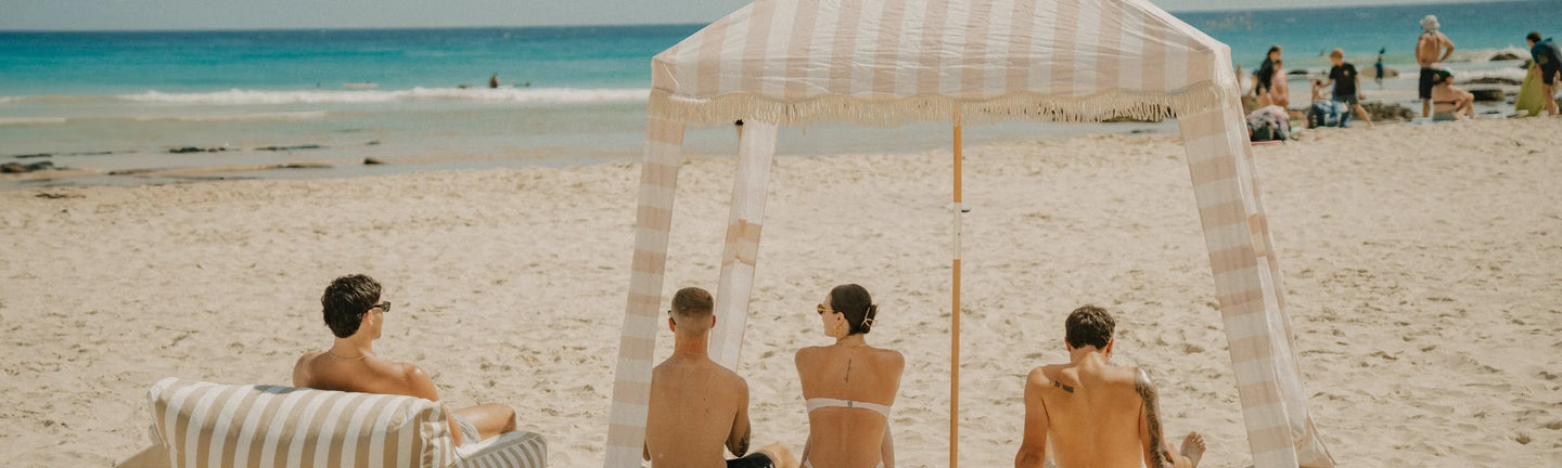 Sand Drift collection products in warm beige and coastal tones styled on the beach.