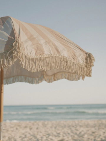 Close-up of the Sand Drift beach umbrella fringe detail swaying in the ocean breeze by House of Dune.