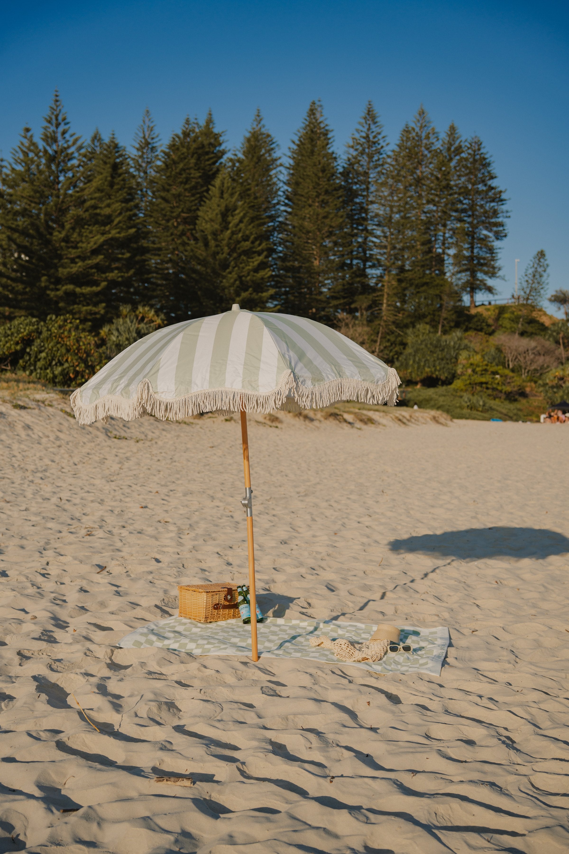Salted Sage Beach Umbrella on the beach by the sea