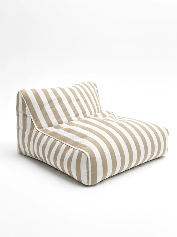 Driftwood Dune floating bean bag lounger in tan and white stripes, featuring a low-profile, armless design for relaxed outdoor coastal living.