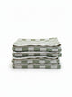 Stack of four House of Dune Salted Sage beach towels in soft green and white checkerboard design, folded for a minimal coastal look.