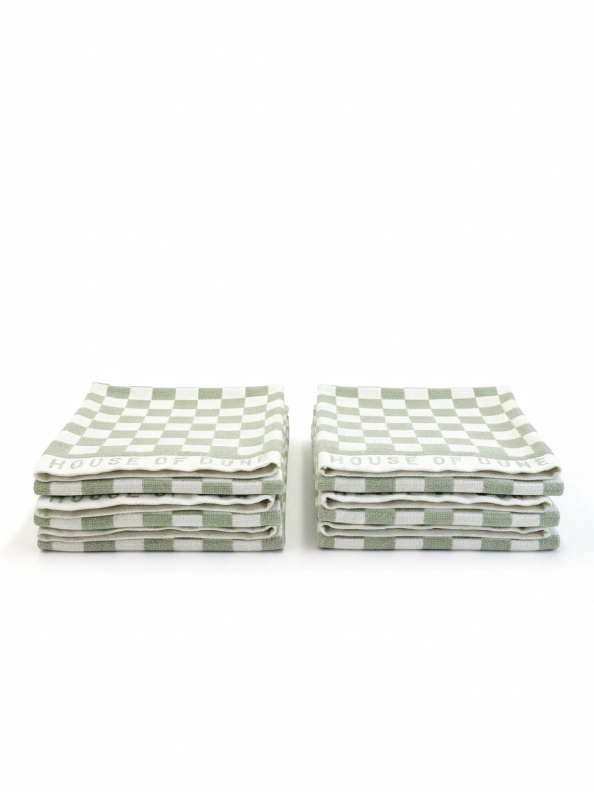 Six House of Dune Salted Sage beach towels folded in two stacks, featuring sage green and white check pattern for modern coastal style.