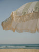Close-up of the Salted Sage beach umbrella fringe swaying in the coastal breeze by House of Dune.