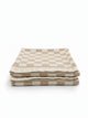Set of two House of Dune Sand Drift beach towels with beige and white checkerboard design, neatly folded on a clean white background.