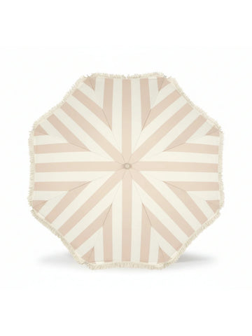 Top-down view of the Sand Drift beach umbrella by House of Dune, featuring soft beige and cream stripes with fringe trim.