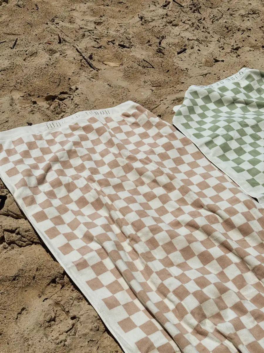 Sand Drift and Salted Sage Beach Towels laid on the sand